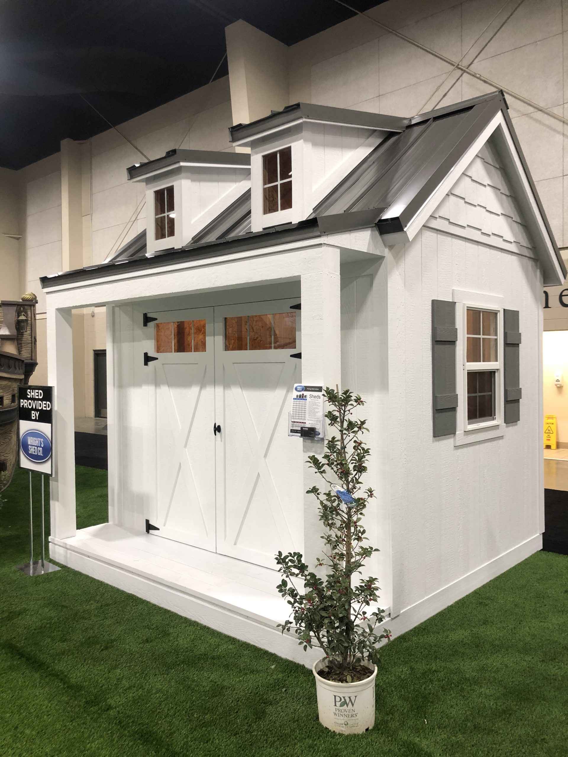 A stylish custom shed with dormer windows and a modern flat roof, provided by Wright's Shed Co.
