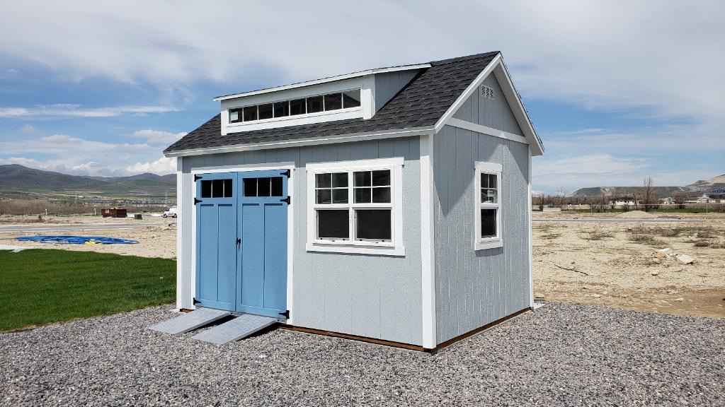 A custom orchard shed with double doors, a window, and a stylish blue exterior.